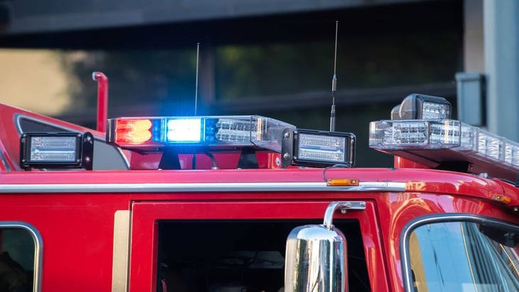 Red and blue blinking lights on top of the firetruck